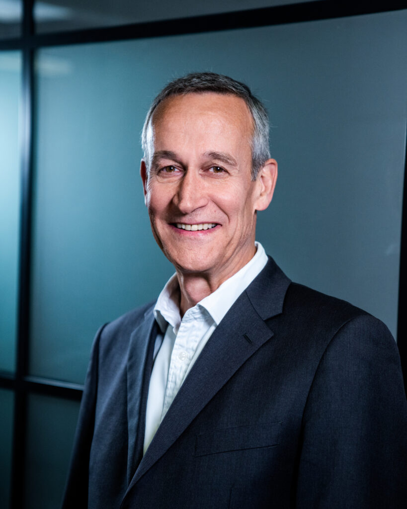 Portrait of Cedric Houghton-Brown standing, professional headshot